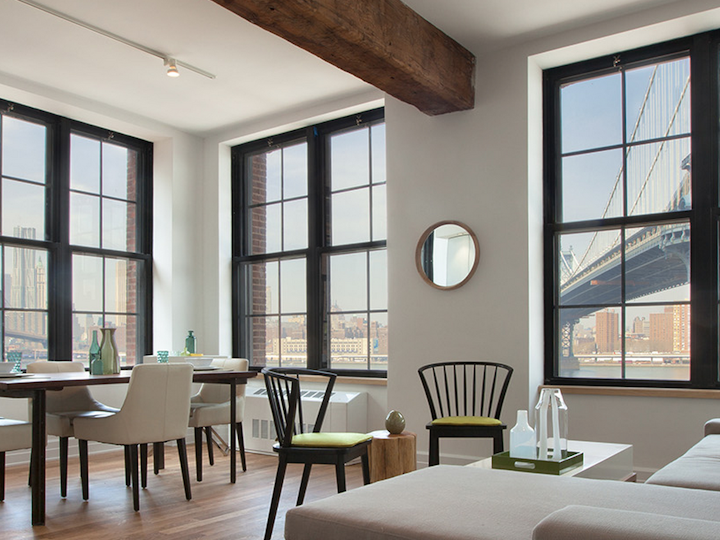 a living room filled with furniture and a large window