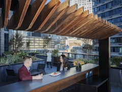 Thumbnail of The Ashland: PH2D a group of people sitting at a table in front of a building