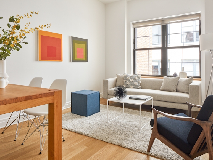 a living room filled with furniture and a large window
