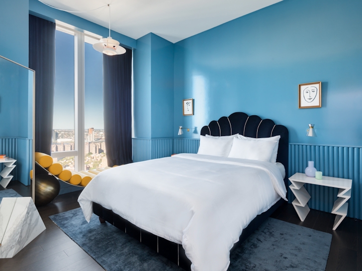 a bedroom with a bed and a chair in a room