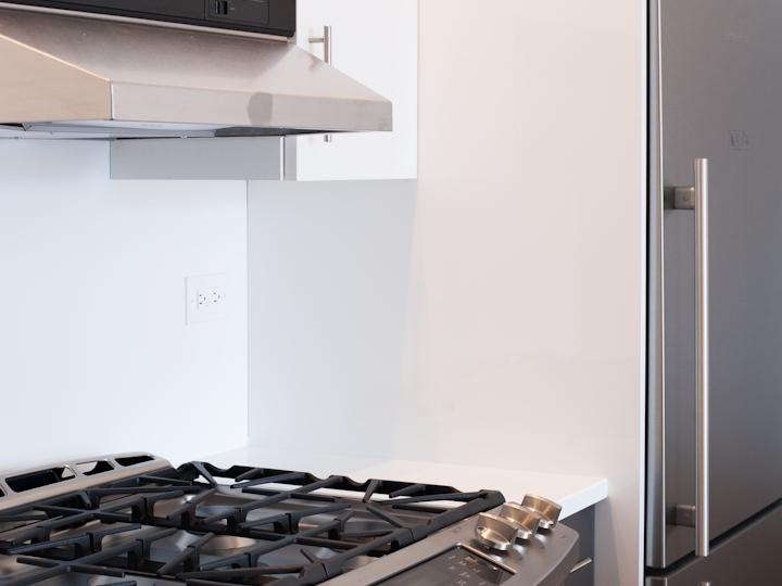 a stove top oven sitting inside of a kitchen