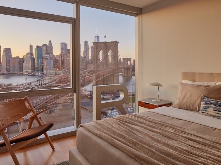 a bedroom with a bed and a chair in a room