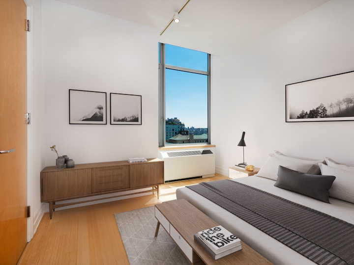 a bedroom with a bed and a mirror in a room