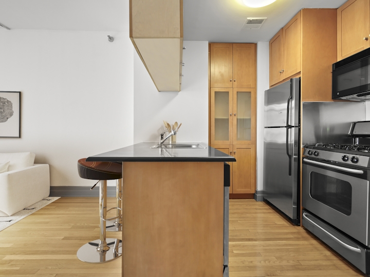 a modern kitchen with stainless steel appliances and wooden cabinets