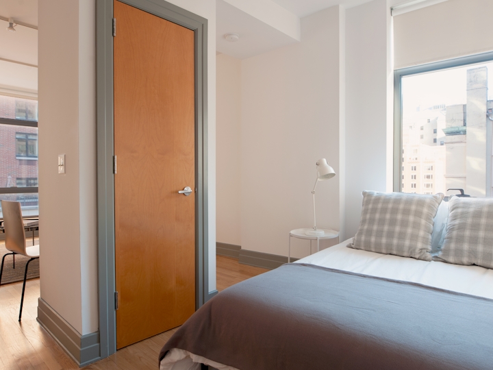 a bedroom with a bed and a window
