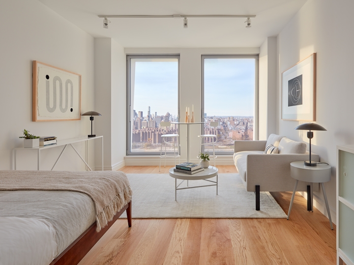 a living room filled with furniture and a large window