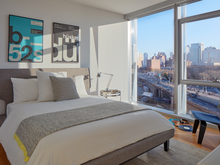 a hotel room with a bed and a large window