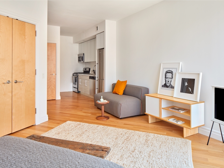 a bedroom with a bed and desk in a room