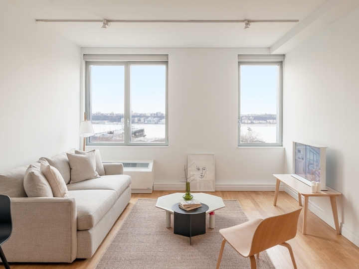 a living room filled with furniture and a large window