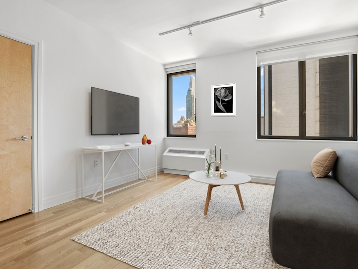 a living room filled with furniture and a large window
