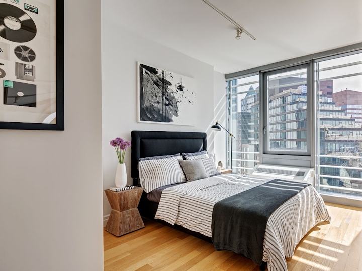 a bedroom with a bed and a chair in a room