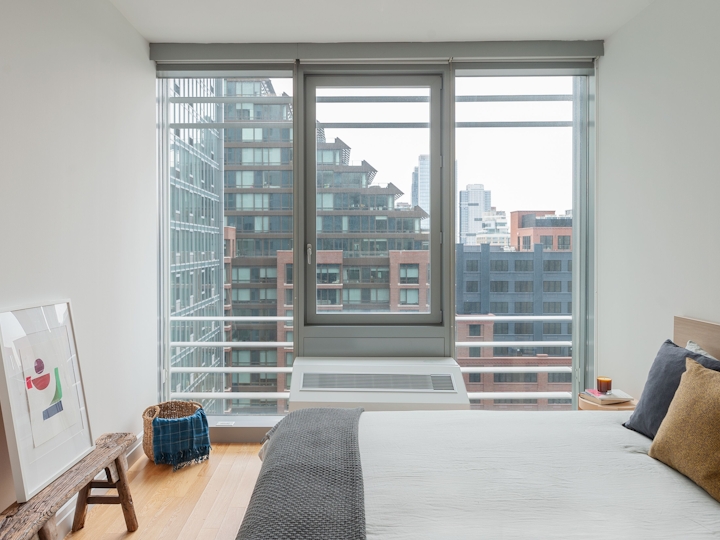 a living room filled with furniture and a large window