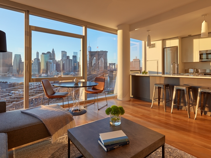 a view of a living room filled with furniture and a large window