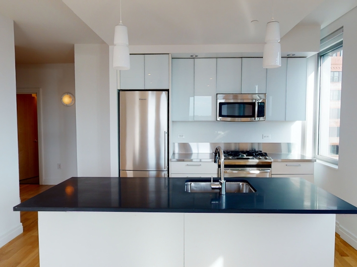 a modern kitchen with stainless steel appliances and wooden cabinets