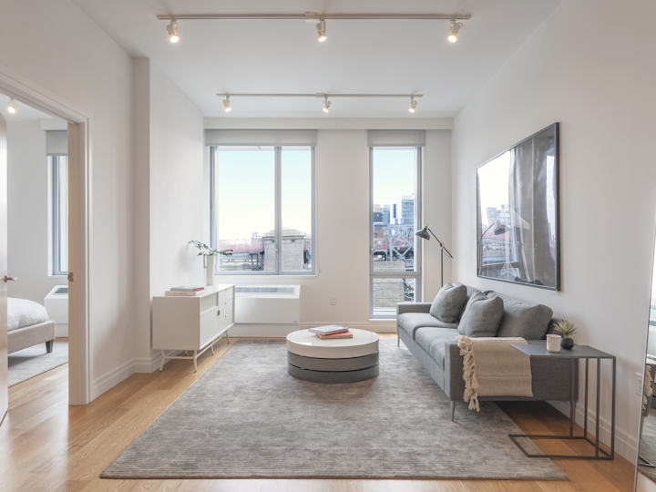 a living room filled with furniture and a large window