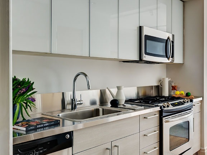 a kitchen with a stove a sink and a microwave