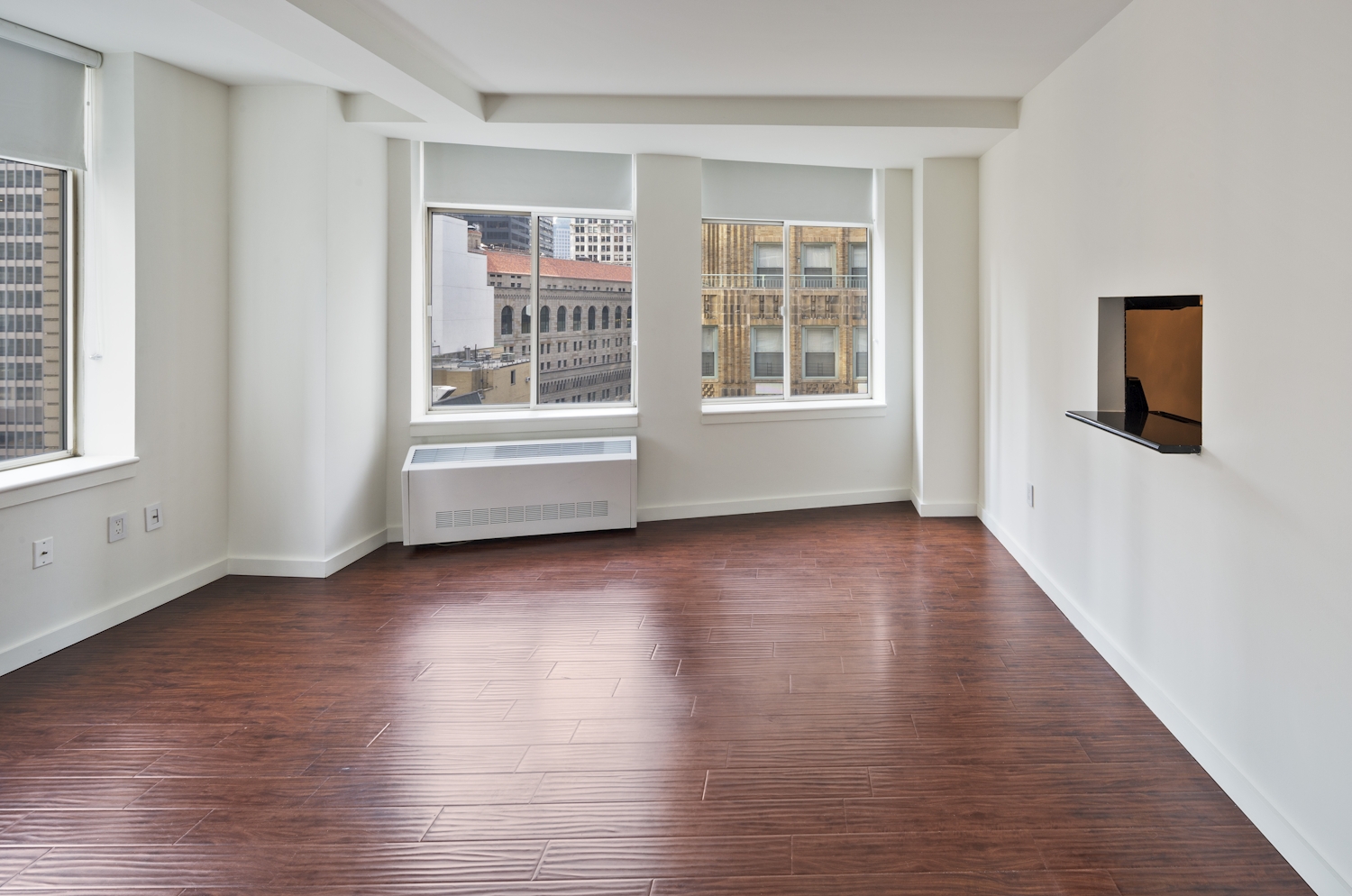 a large empty room with a hard wood floor