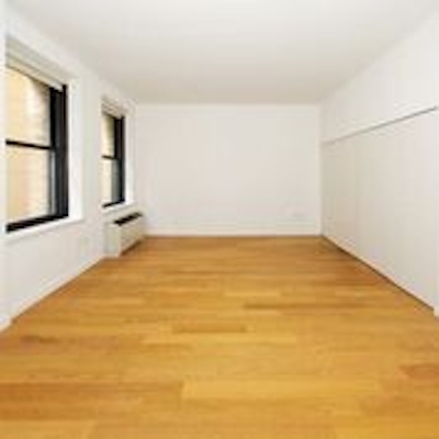 a large empty room with a wood floor