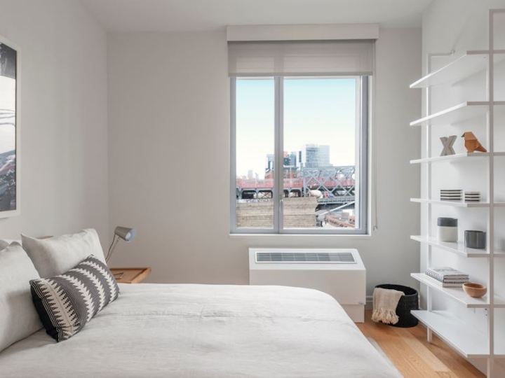 a bedroom with a bed and a window