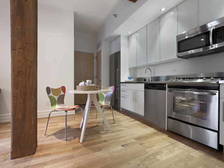 a room filled with furniture and a stove in a kitchen