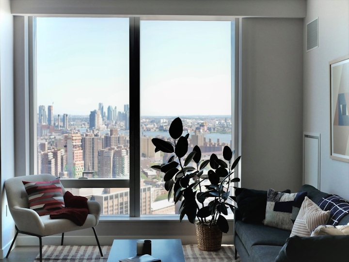 a view of a living room filled with furniture and a large window