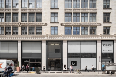a group of people walking in front of a building