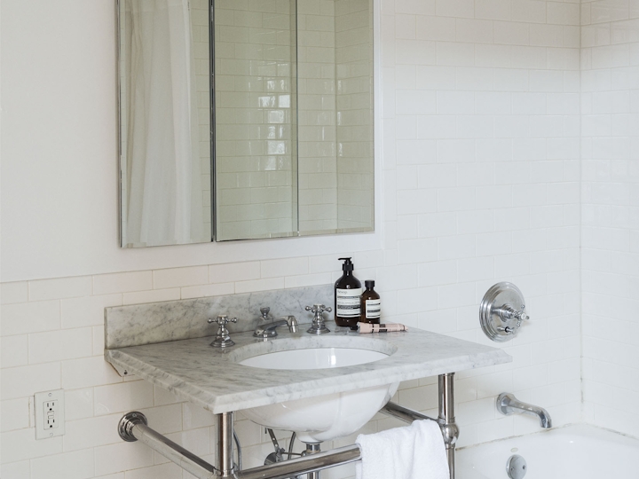 a room with a sink and a mirror