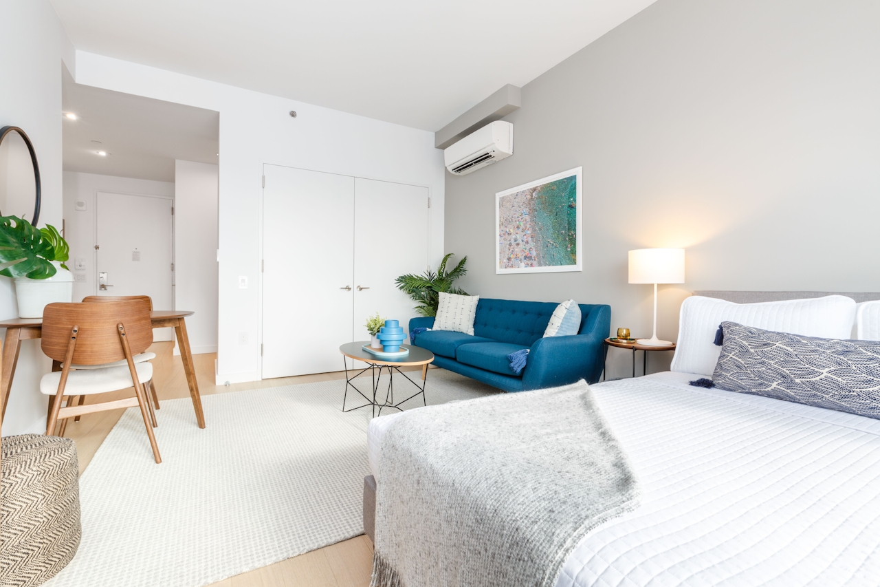 a bedroom with a bed and a chair in a room