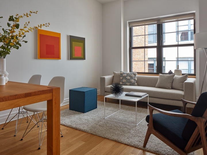 a living room filled with furniture and a large window