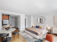 Thumbnail of The Nicole: 5C a bedroom with a bed and desk in a room