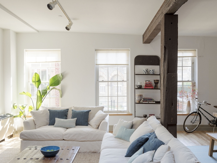 a living room filled with furniture and a large window
