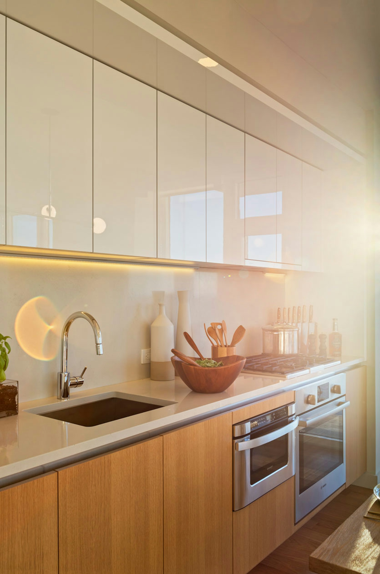 a kitchen with a sink and a mirror