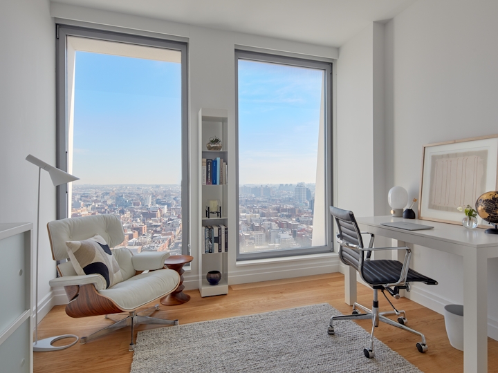 a living room filled with furniture and a large window
