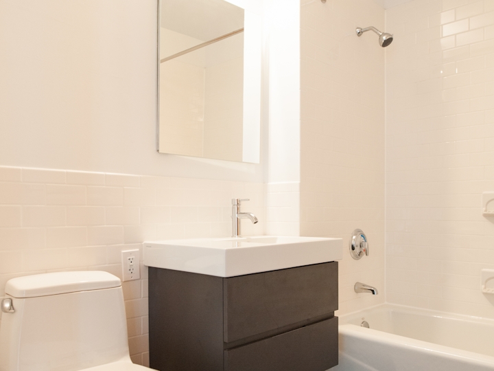 a white tub sitting next to a shower