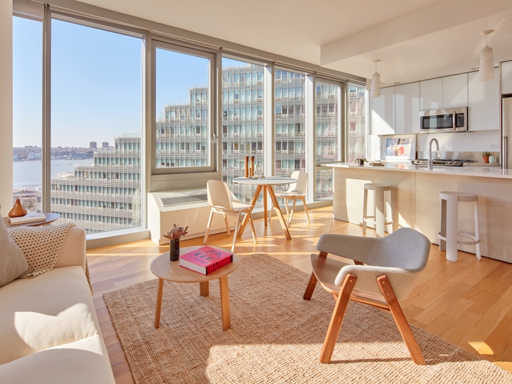 a living room filled with furniture and a large window