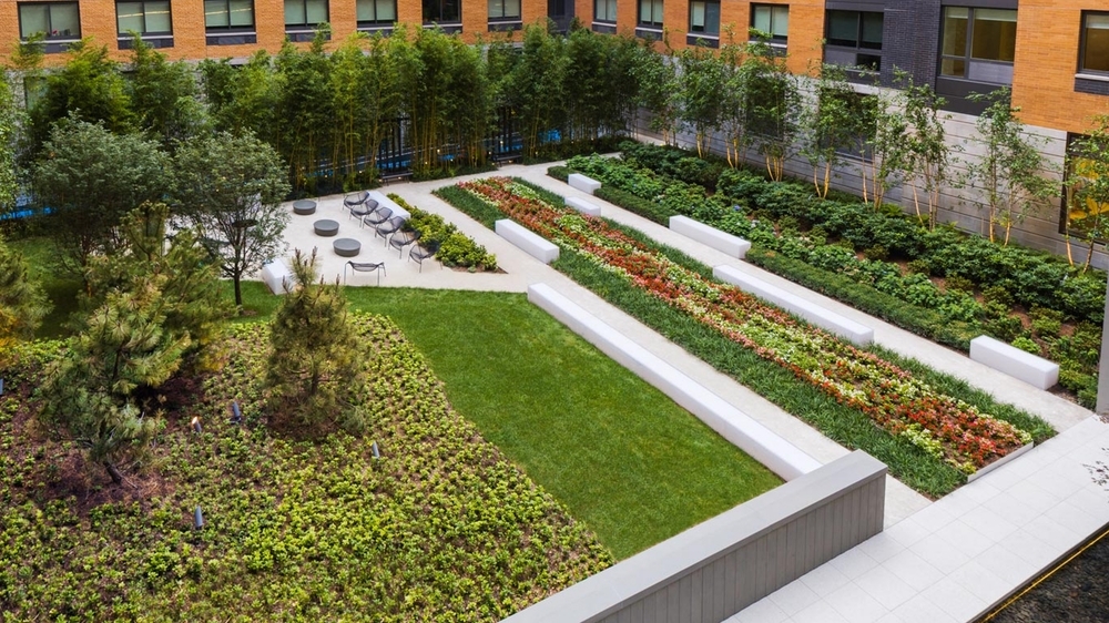 Gotham West: 2717 a large brick building with green grass