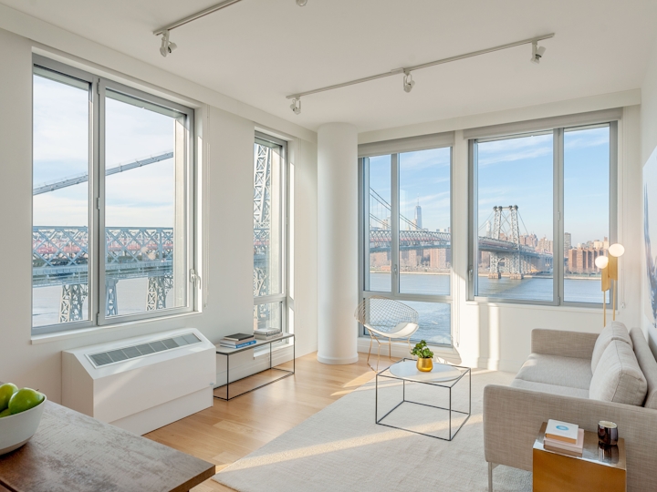 a living room filled with furniture and a large window