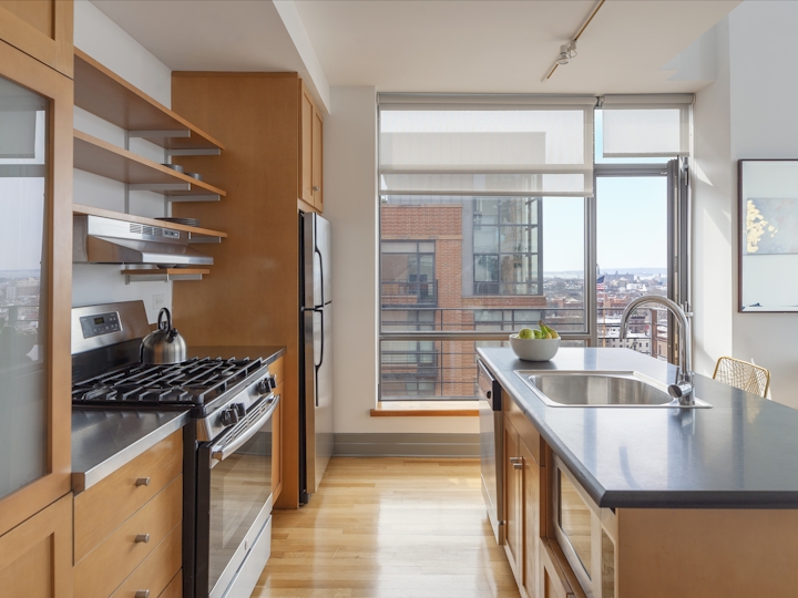 a modern kitchen with stainless steel appliances and wooden cabinets