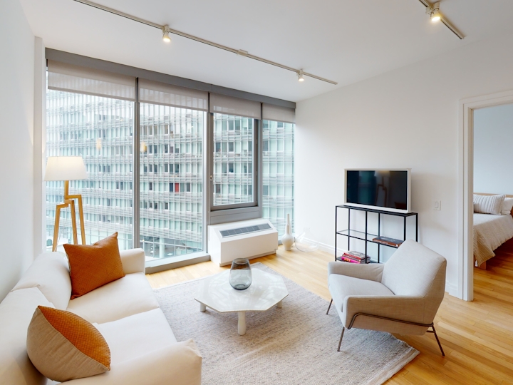 a living room filled with furniture and a flat screen tv