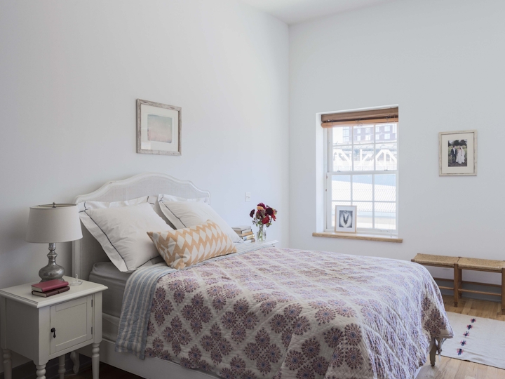 a bedroom with a bed in a room