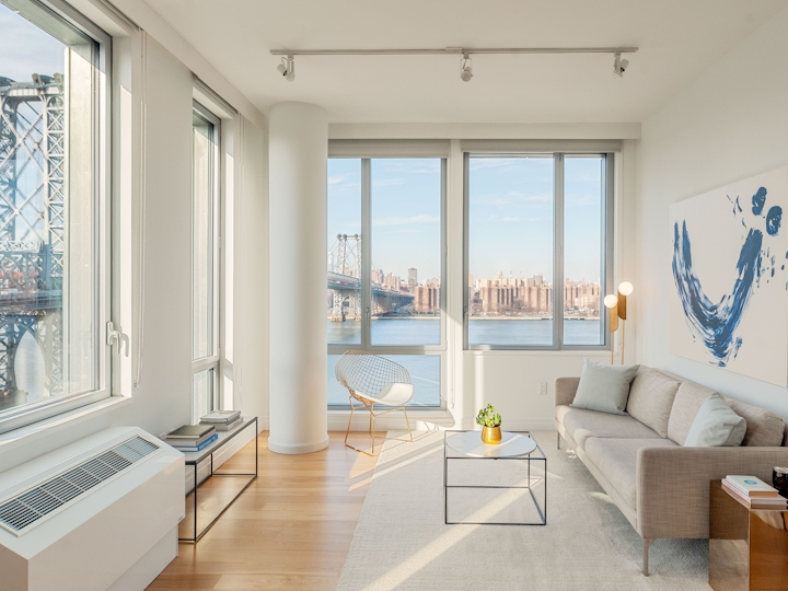 a living room filled with furniture and a large window