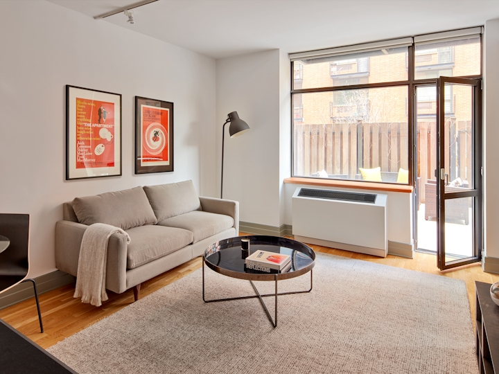 a living room filled with furniture and a large window