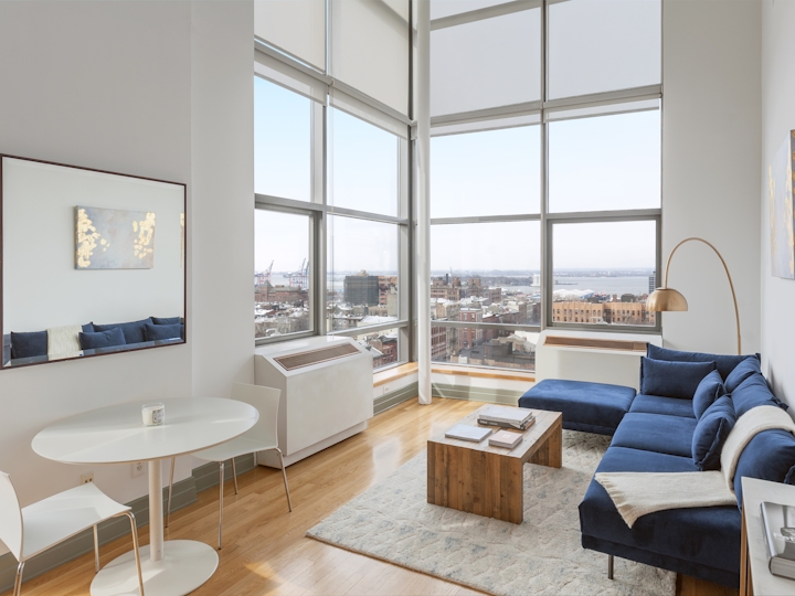 a living room filled with furniture and a large window
