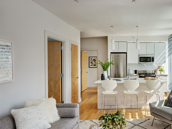 a living room filled with furniture and a large window