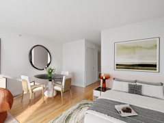 Thumbnail of The Nicole: 11D a living room filled with furniture and a flat screen tv