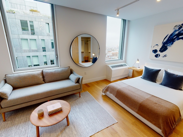 a room with a couch a table and looking at the camera