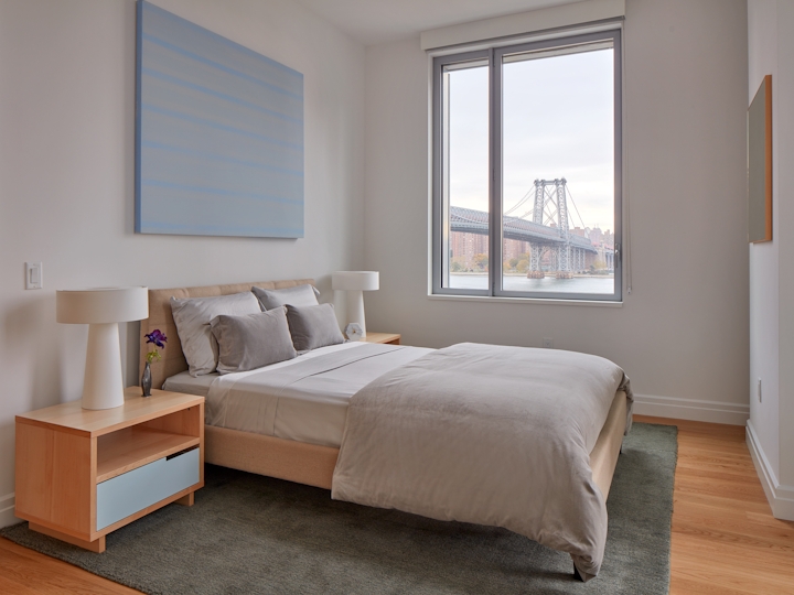 a bedroom with a bed and a large window