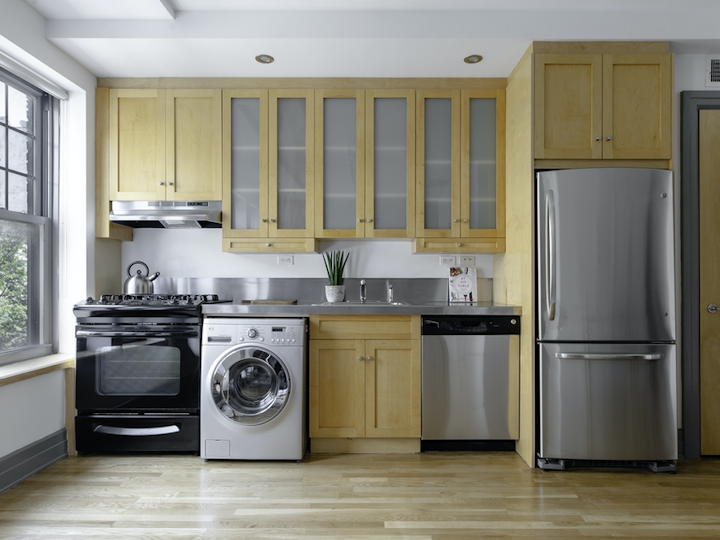 a kitchen with white appliances and wooden cabinets