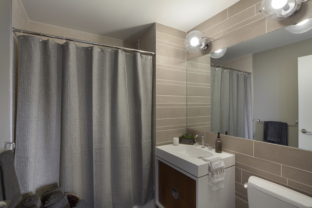 Gotham West: 2717 a white sink sitting next to a shower curtain