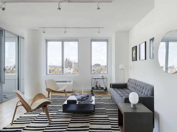 a living room filled with furniture and a large window